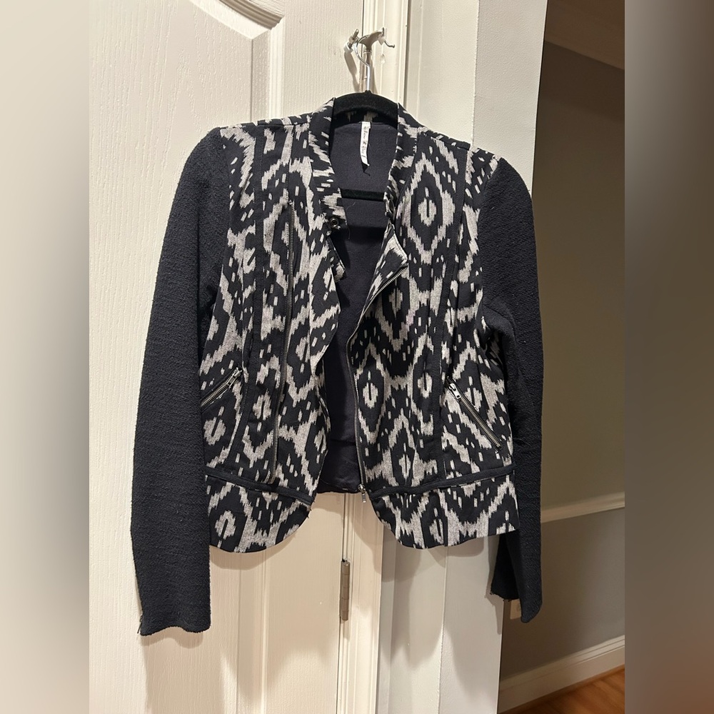 Light weight blazer with zipper up front off center.